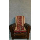 A mid 20th century leather armchair with kelim covered back and seat. H.88cm