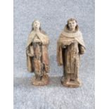 Two antique painted terracotta figures. One of a monk holding a candle and a bible and the other