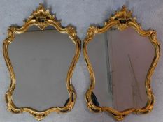 A pair of gilt rococo style shell carved mirrors. H.85 W.59cm