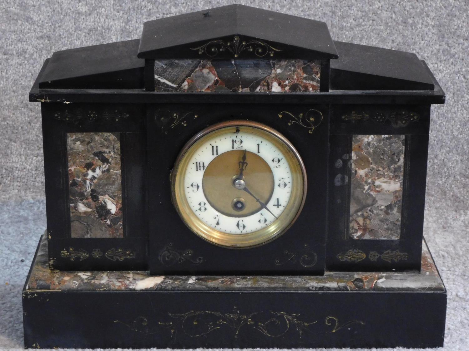 A Victorian style black slate and marble mantle clock. With white enamel and brass dial. Engraved