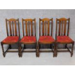 A set of four antique style carved oak dining chairs on stretchered barleytwist supports. H.95cm