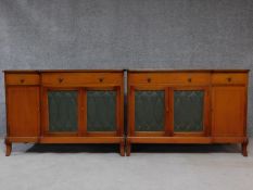 A pair of mid 20th century Georgian style mahogany sideboards, symmetrically designed with a
