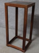 A contemporary teak plant stand raised on stretchered supports. H.87 W.41 D.41cm