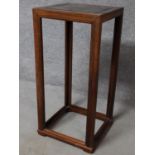 A contemporary teak plant stand raised on stretchered supports. H.87 W.41 D.41cm