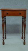 A late 19th century mahogany bedside table with frieze drawer, raised on turned tapering supports.