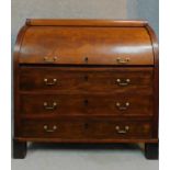 A 19th century continental mahogany cylinder top bureau with tooled leather lined slide out
