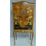 A lacquered Chinoiserie style drink's cabinet mirrored interior and glass shelves, raised on shell