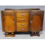 A mid-20th century Art Deco style oak carved sideboard with fitted drinks compartment to door