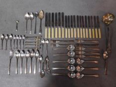 A collection of silver and silver plated cutlery. Including a Scottish silver mustard spoon,