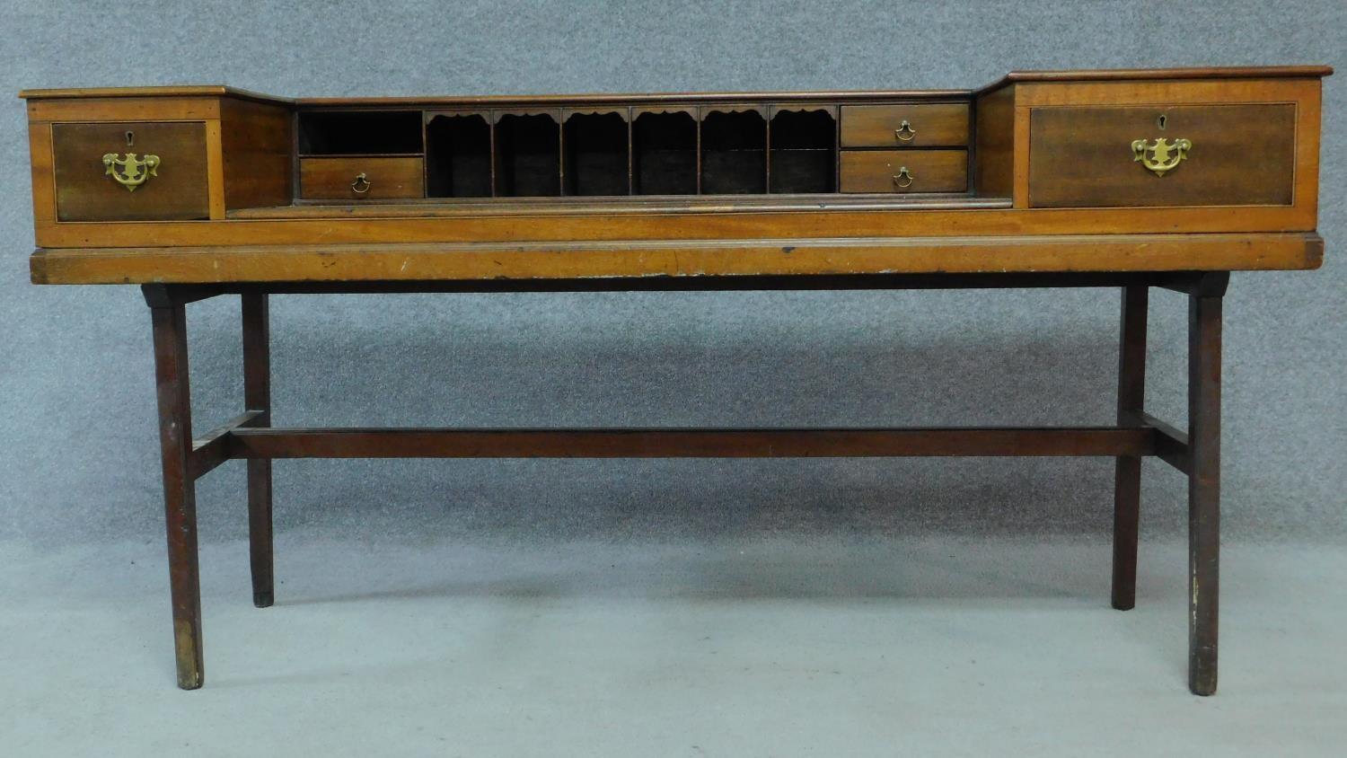 An early 20th century mahogany converted piano writing desk raised on stretchered square supports.