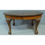 A late 19th century mahogany extending D-end dining table the gadrooned top above carved cabriole
