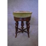 A Victorian walnut piano stool with adjustable tapestry upholstered seat. H.48 x 38cm