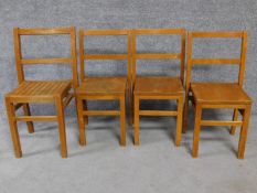 Four vintage oak children's school chairs on square stretchered supports. H.69cm