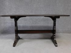 A vintage elm refectory style dining table on stretchered supports, by Ercol. H.72 W.77 D.152cm