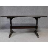 A vintage elm refectory style dining table on stretchered supports, by Ercol. H.72 W.77 D.152cm