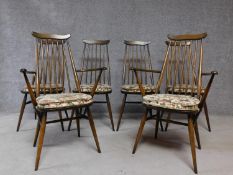 A set of six vintage Ercol Goldsmith model elm dining chairs with tapestry covered squab cushions.