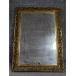 A framed giltwood floral carved bevelled wall mirror. 109x78cm