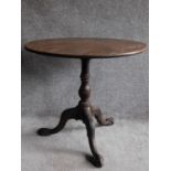 A Georgian mahogany circular tilt top occasional table on well carved tripod cabriole base