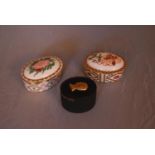 Three bone china and ceramic trinket boxes. Two by Royal Crown Derby, Wild Rose and Honeysuckle