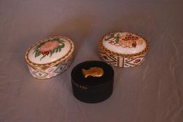Three bone china and ceramic trinket boxes. Two by Royal Crown Derby, Wild Rose and Honeysuckle