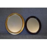 An oval gilt framed mirror and another similar. H.72 x 62cm