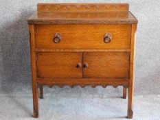 A mid 20th century oak cabinet with frieze drawer above panel doors on square supports. H.82 W.77