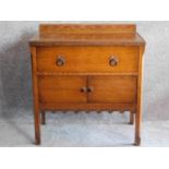 A mid 20th century oak cabinet with frieze drawer above panel doors on square supports. H.82 W.77