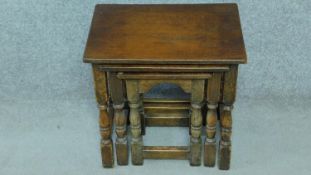 A Jacobean style oak nest of three tables on stretchered turned supports. H.43 W.44 D.31cm