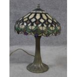 A Tiffany style iridescent stained glass table lamp. Shade has a repeating geometric design