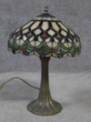 A Tiffany style iridescent stained glass table lamp. Shade has a repeating geometric design