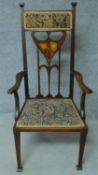 An Arts & Crafts mahogany and satinwood inlaid armchair with stylised motifs to the back splat in