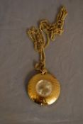 A vintage Tegrov gold tone pendant antimagnetic watch and chain. Impressed floral design to the back