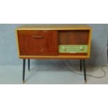 A 1960's vintage satin walnut and teak dancette supports radiogram, by Philips. H.76 W.92 D.36