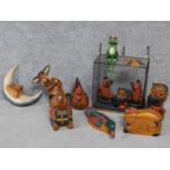 A collection of painted wooden figures of animals and a moon. With a wire basket. H.30cm