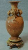 A vintage Chinese carved soapstone vase on five legged stand. With carved chrysanthemum detailing.