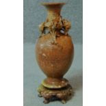 A vintage Chinese carved soapstone vase on five legged stand. With carved chrysanthemum detailing.