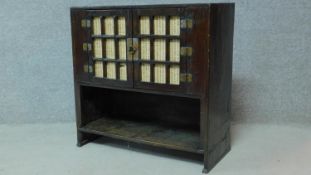 A Chinese hardwood cabinet with panel doors above open compartment. H.71 W.78 D.34cm