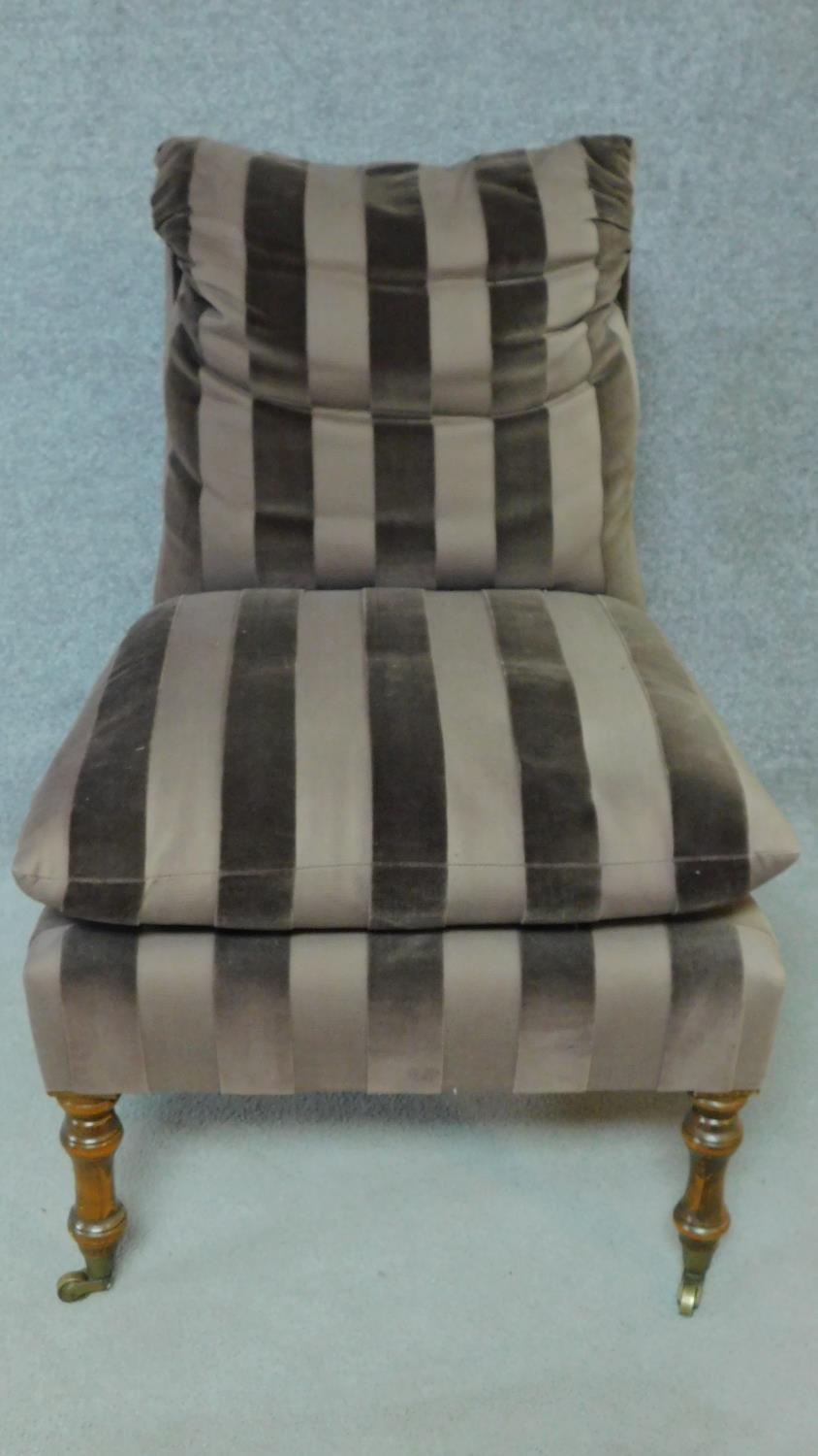 A 19th century style nursing chair in striped upholstery on turned tapering supports. H.87cm - Image 2 of 4