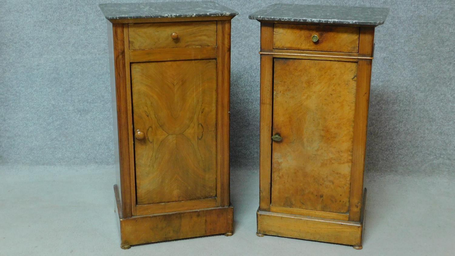 A near pair of 19th century Continental walnut bedside cabinets with grey veined marble tops and