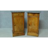 A near pair of 19th century Continental walnut bedside cabinets with grey veined marble tops and