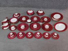 A complete Wedgwood Ulander powder ruby gilded dinner service.