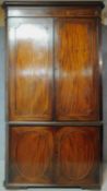 A Georgian mahogany and satinwood strung two section floor standing full height corner cupboard with