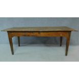An antique oak planked top refectory dining table with cleated ends and twin end drawers on square