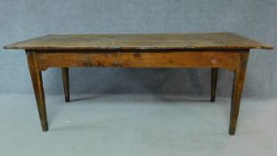 An antique oak planked top refectory dining table with cleated ends and twin end drawers on square