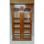 A 19th century mahogany full height floor standing bookcase with a pair of glazed doors enclosing