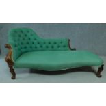 A Victorian rosewood framed chaise longue in buttoned back upholstery on carved cabriole supports.