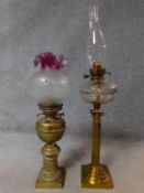 Two Victorian brass oil lamps. One with ridged column design on a square base and the other with