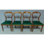 A set of four Victorian mahogany balloon back dining chairs on turned tapering supports. H.87cm