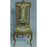 A Victorian rosewood floral carved and upholstered prie dieu chair raised on cabriole legs. H.111cm