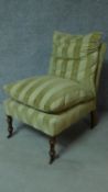 A 19th century style nursing chair in striped upholstery on turned tapering supports. H.87cm